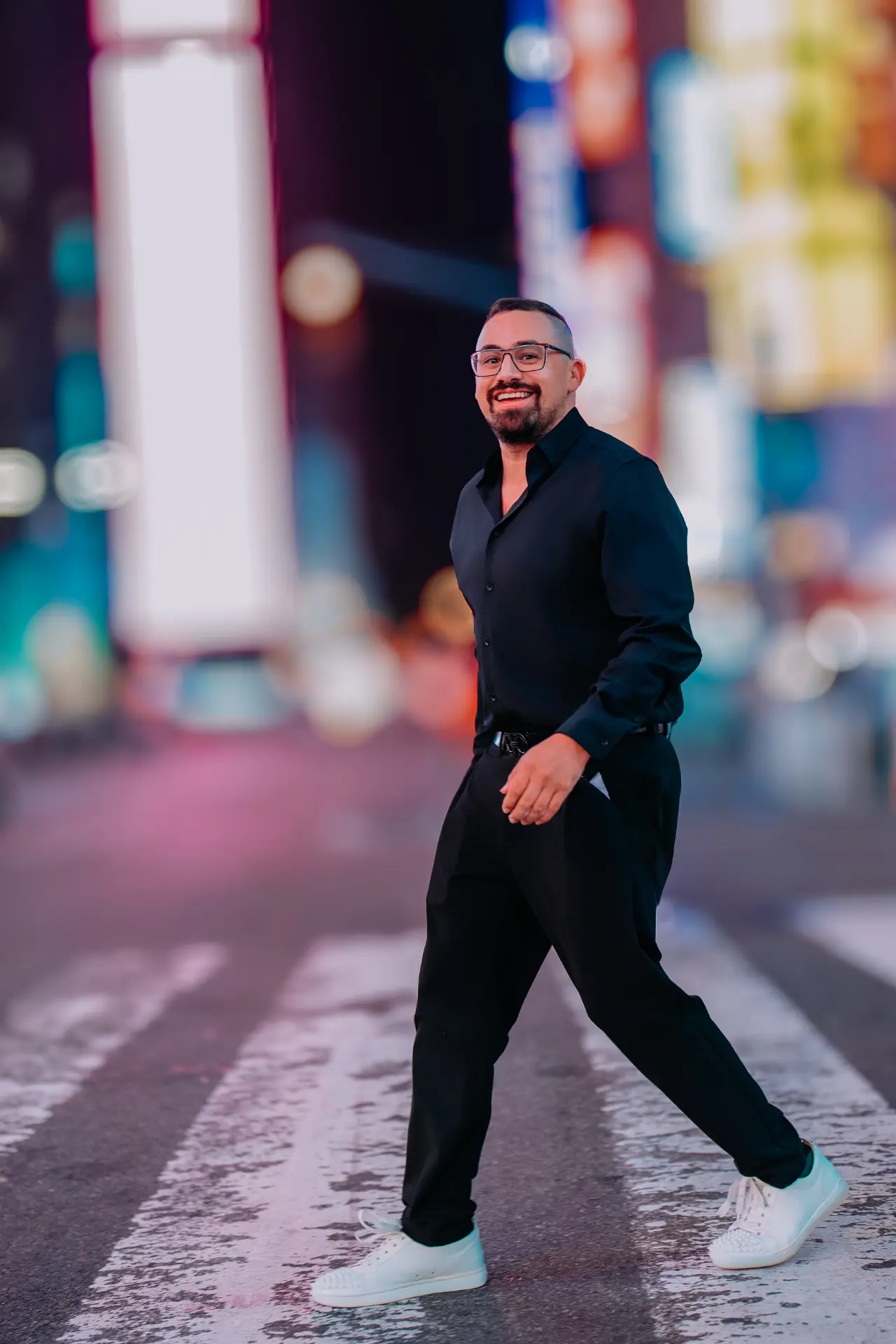 Ryan Salinas, Creative Director of URBN Events, walking across a city crosswalk